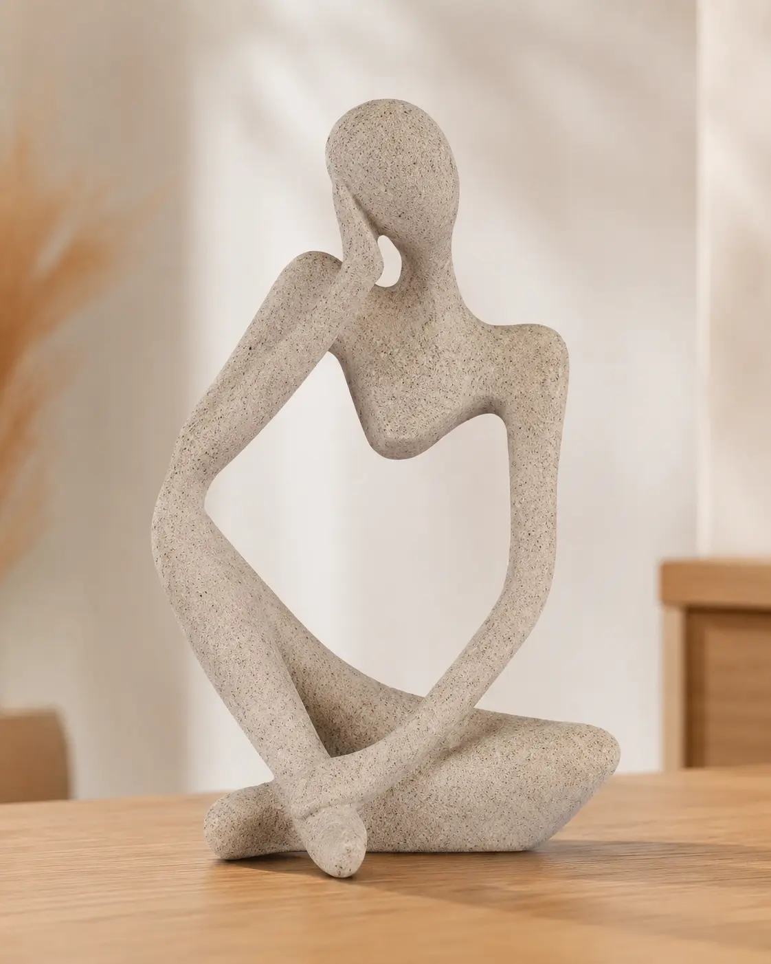 Ozzptuu sandstone resin thinker style abstract sculpture on a desk
